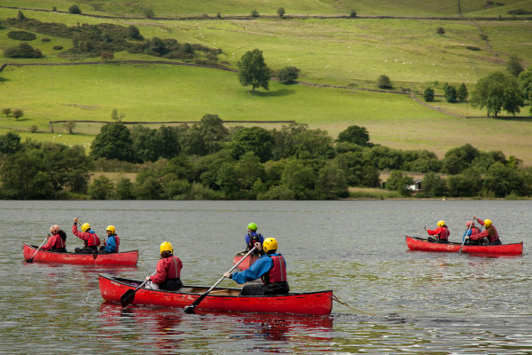 Group of young people canoeing