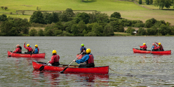 Group of young people canoeing