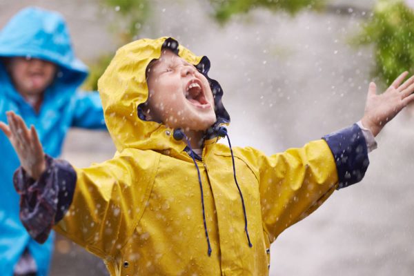 Child standing in the rain