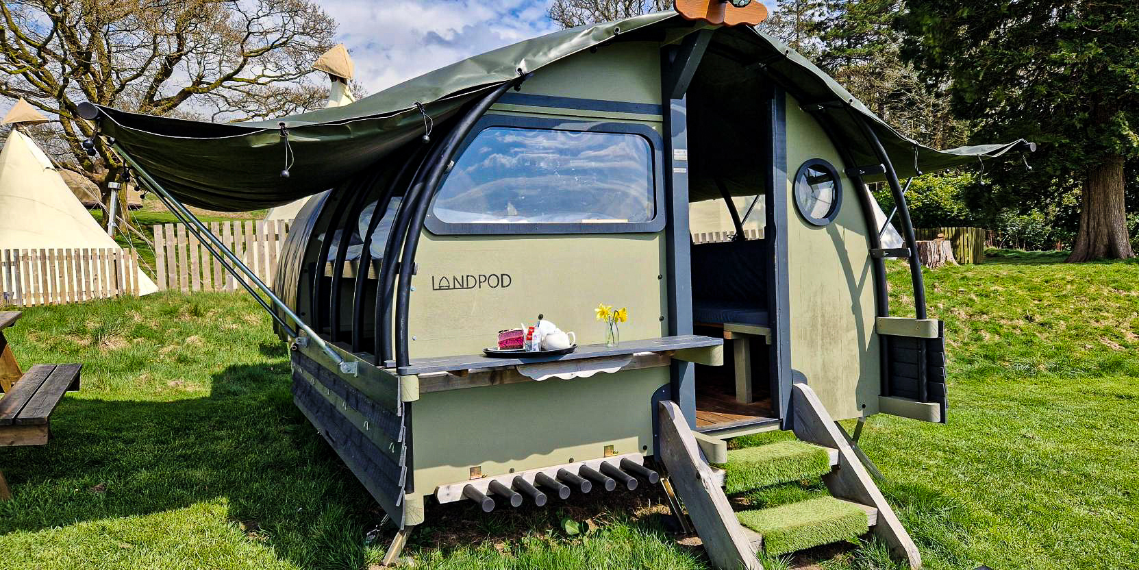 Landpod with sides open and tea and coffee on the shelf