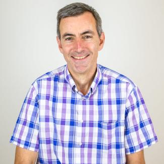 Man wearing a blue and purple checked shirt