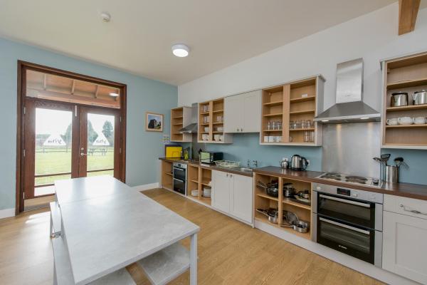 YHA National Forest kitchen with dining table and doors to the outdoor space