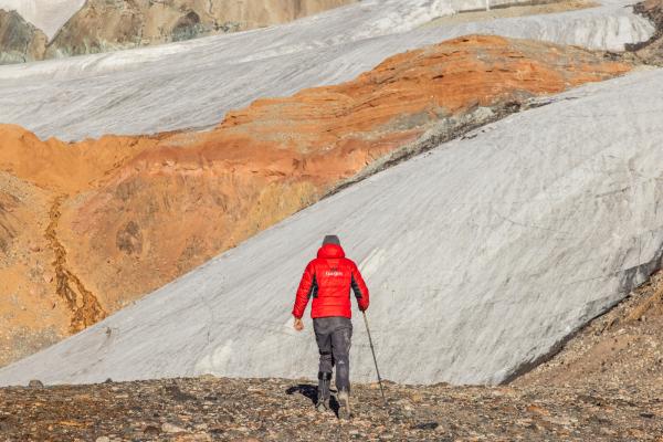 Man walking towards mountainous scenery