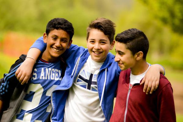 Three smiling children on a YHA school trip