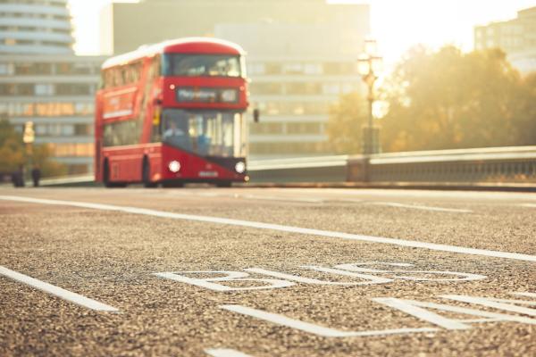 Red double decker bus on a city road