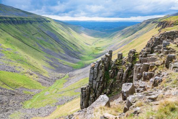 Rocky valley landscape with jagged rocks in the foreground