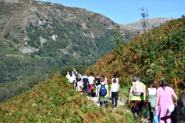 School children walking through mountains