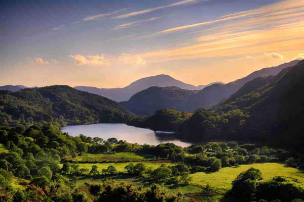 Sunrise over a lake and rollings hills