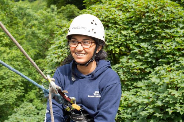 Young female student abseiling at YHA Edale