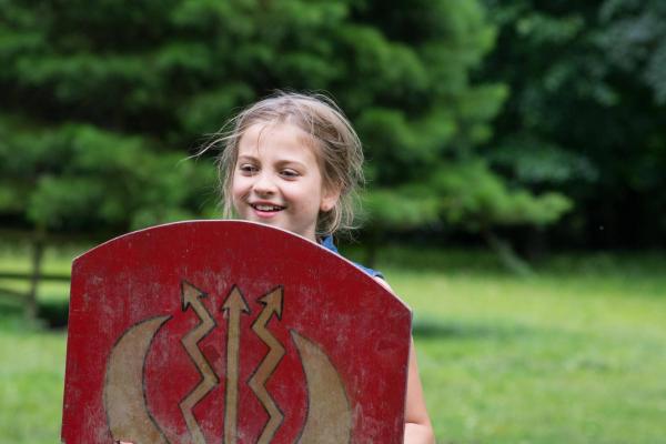 Young female student holding a battle shield at YHA Castleton