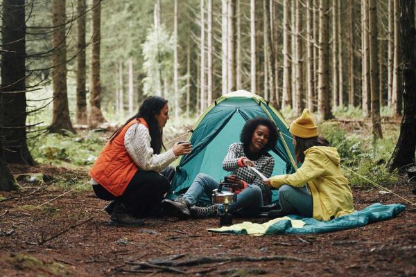 Group of women camping in a forest