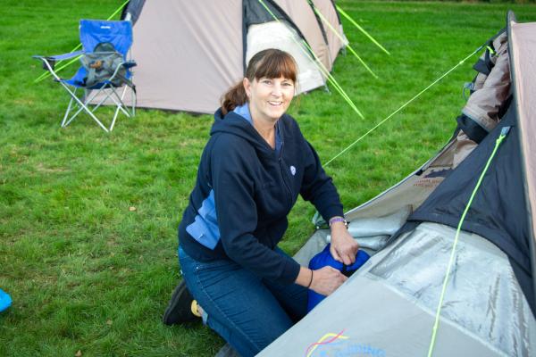 Woman by tent outdoors
