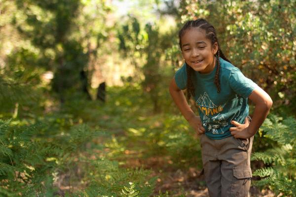 Child smiling in a forest