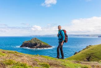 Man hiking on the coast Man-hiking-on-the-coast
