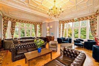 Lounge with plenty of seating and a view out into the garden Lounge / common room