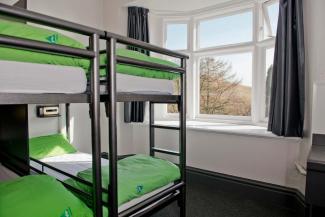 Bedroom with multiple bunk beds and view from window YHA Edale Bedroom Image