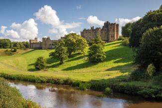 Magnificent castle overlooking green hills and a wide river