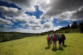 Hikers walking across the Cotswolds YHA Cotswolds Hikers