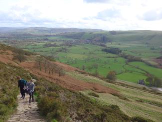 Children climbing a path up a hill in the Peak District