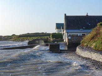 Exterior view of YHA Port Eynon Exterior with sea