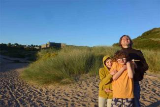 Family smiling at the beach