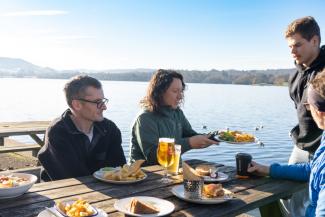Friends enjoying lunch next to Lake Windermere