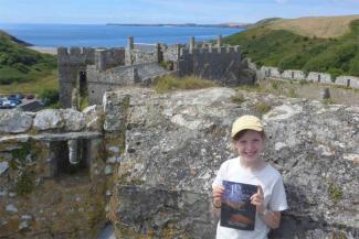 Young girl smiling outside some castle ruins