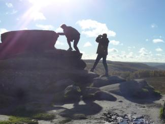 Men climbing rock formation
