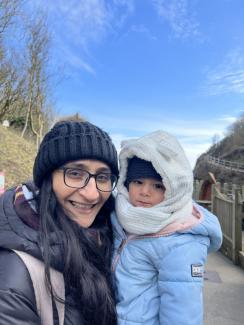 Nisbah Hussain with her child smiling at the camera