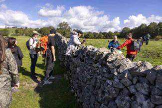 People climbing through a stile in the countryside