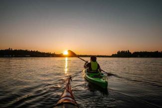 Two people kayaking on a lake Two people kayaking on a lake