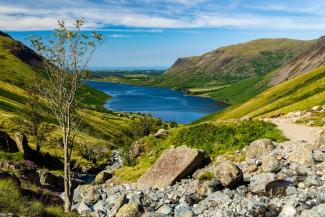 Large blue lake surrounded by green rolling hills