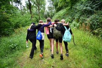 Young people with their arms round each other