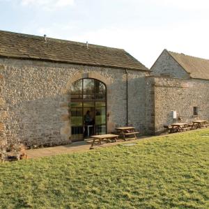 Grey stone building surrounded by grass