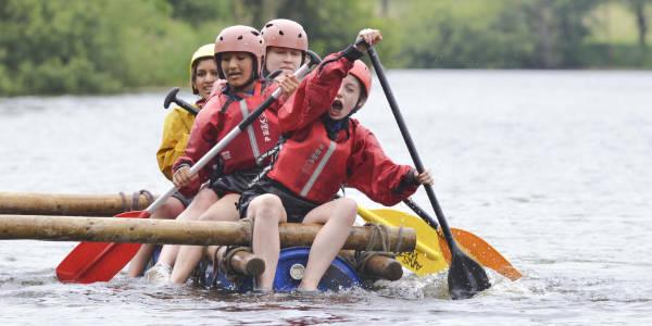 Group of female students steering a raft at YHA Edale