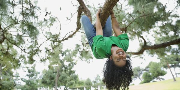 Woman climbing tree