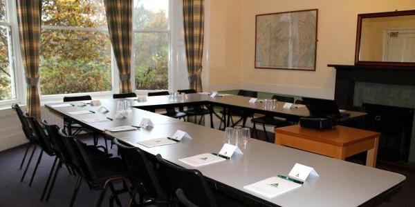 Meeting room at YHA Grasmere Butharlyp Howe with u-shaped table configuration and chairs
