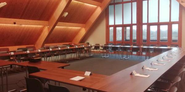 Mezzanine meeting room at YHA London Lee Valley with long wooden tables and chairs