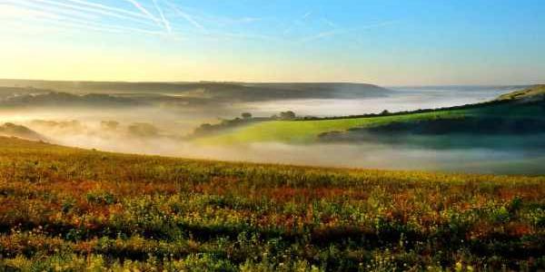 View of Cuckmere Valley at sunrise with mist