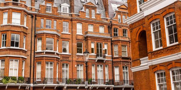 Facade of opulent British Victorian Edwardian terraced flat in red bricks in Chelsea, London.