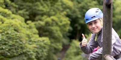 Primary school child participating in abseiling at YHA Edale