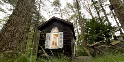 Anglesey hut by the trees at YHA Idwal Cottage Wooden hut surrounded by trees