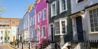 Colourful houses in Chelsea, London Row of terraced houses painted in different shades of pink, purple and blue