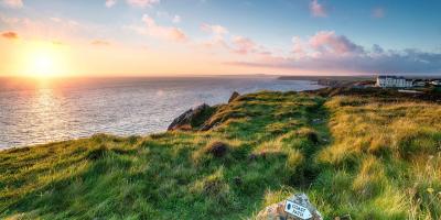 View of sea over cliffs at sunset, Lizard, Cornwall