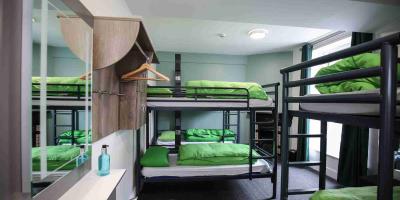 Dorm room at YHA Keswick Large bedroom with bunk beds and a mirror over a washbasin