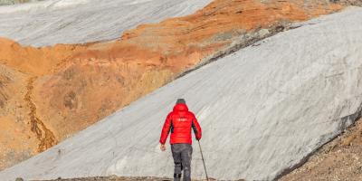 Man walking towards mountainous scenery