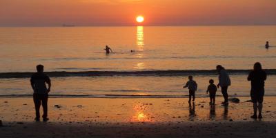 Family on Broad Haven beach at sunset