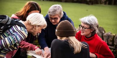 Group of women looking at a map outside