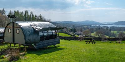 Landpod at YHA Windermere Glamping Landpod on a grass field overlooking a lake