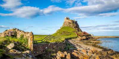Rocky bay and building on top of a hill overlooking the sea
